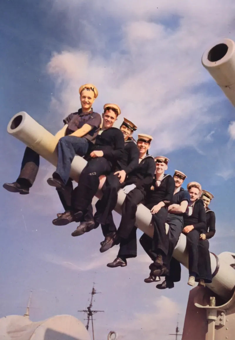 Navy Sailors sitting on a cannon