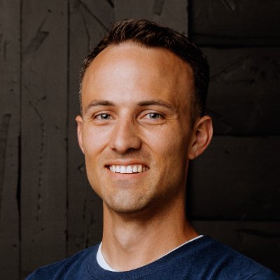 A man in a blue shirt smiling at the camera