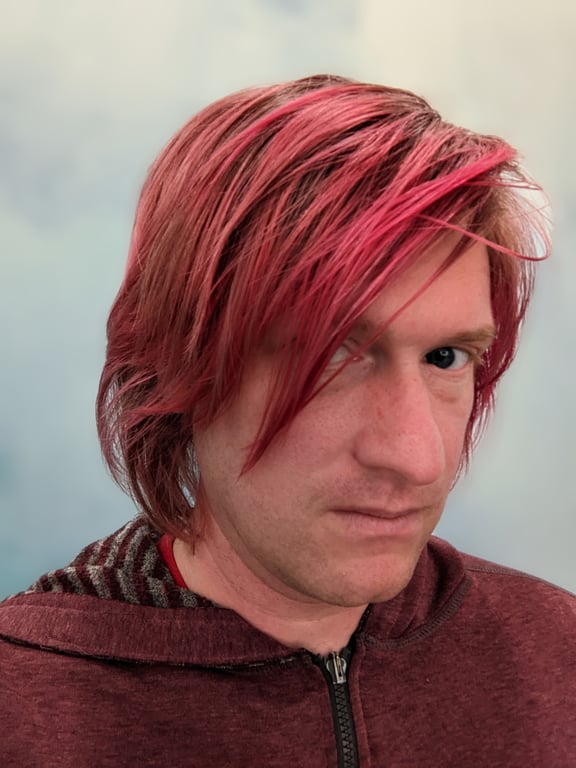 A man with pink hair and a red hoodie